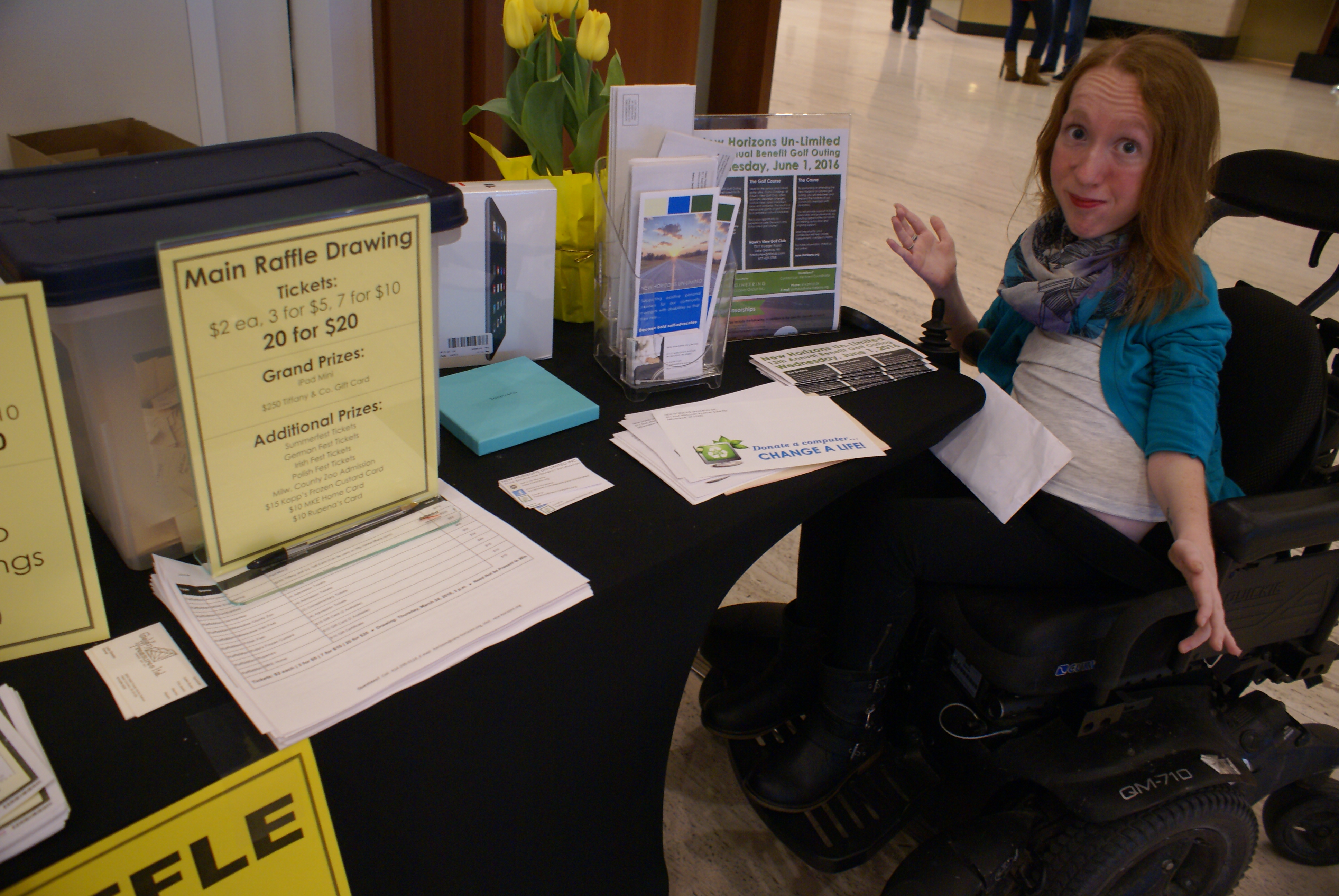 Staff member happily displaying event table