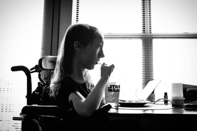 A Story of Being Human Woman in a wheel chair at a table