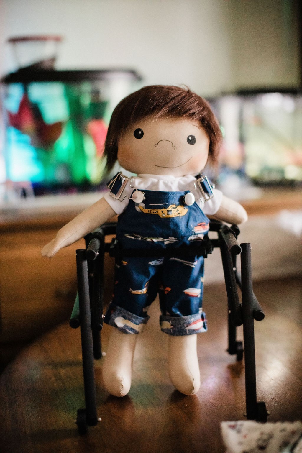 A Story of Being Human: Representation Matters Color photograph of a custom made doll with a walker