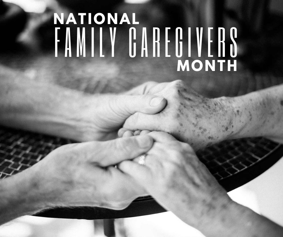 A black and white photo of two people holding hands