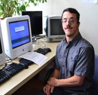 Sean seated at computer work bench